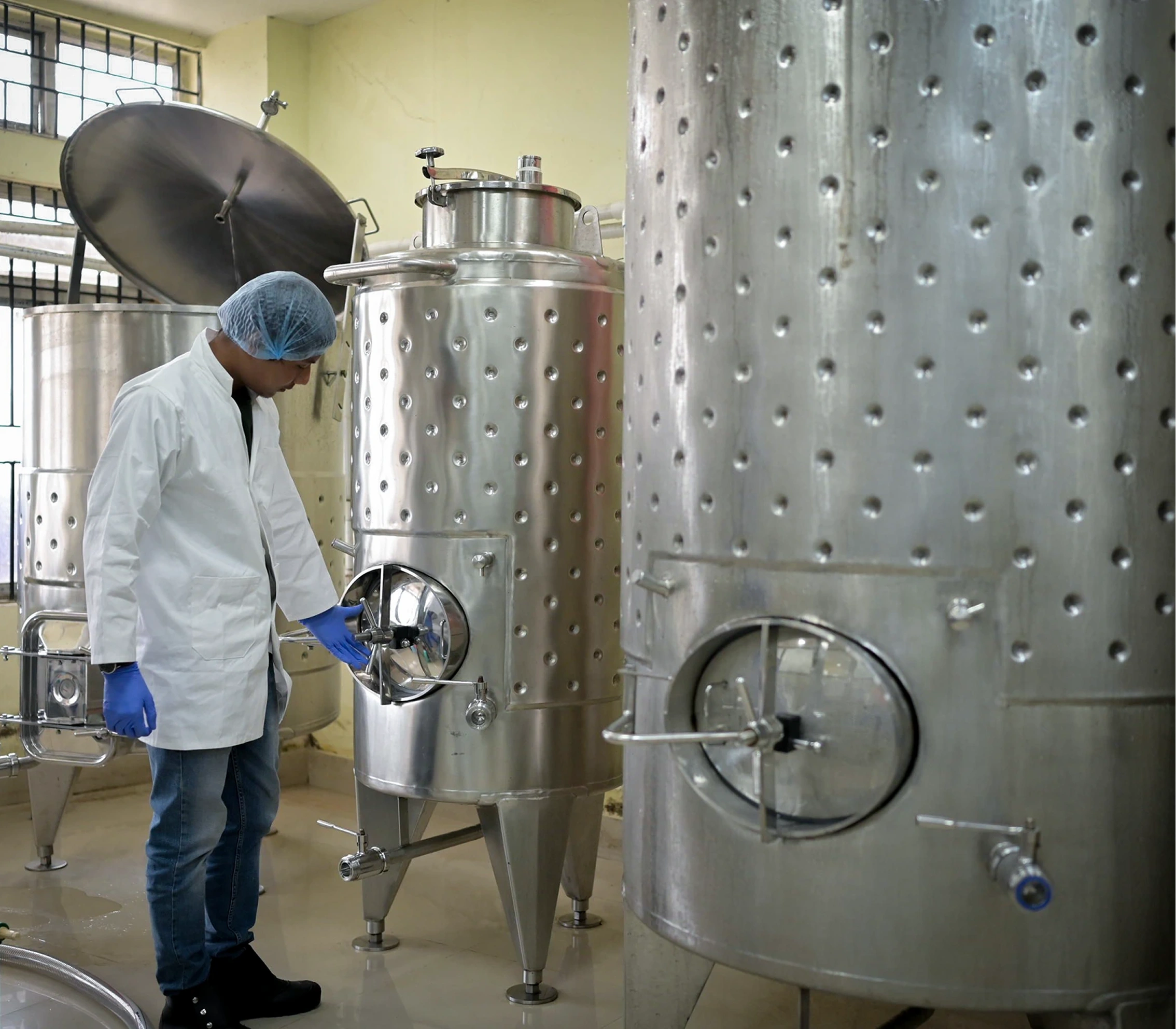 Traditional winery with worker overseeing the process